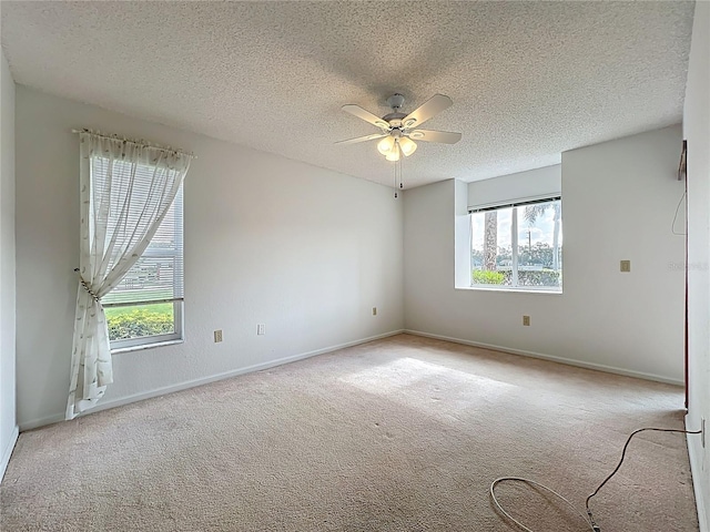 4382 Madeira Ct Unit 3361, Sarasota, FL 34233 - empty room featuring plenty of natural light, a textured ceiling, carpet flooring, and a ceiling fan