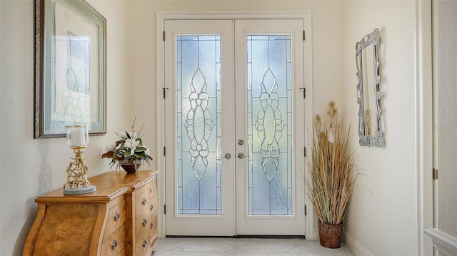 doorway featuring light tile patterned flooring and french doors