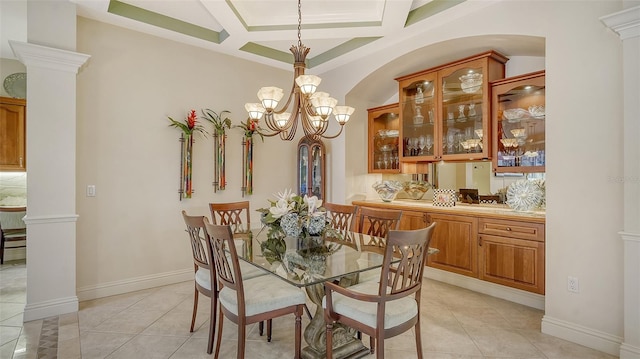 dining space featuring beam ceiling, ornate columns, coffered ceiling, an inviting chandelier, and light tile patterned floors