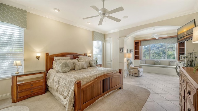 bedroom with light tile patterned floors, decorative columns, ceiling fan, and ornamental molding