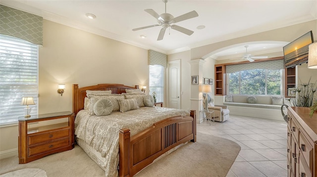 21 Bayhead Ln, Osprey, FL 34229 - bedroom with crown molding, arched walkways, a ceiling fan, and light tile patterned floors