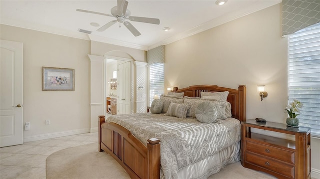 21 Bayhead Ln, Osprey, FL 34229 - bedroom with crown molding, light tile patterned flooring, ceiling fan, arched walkways, and ensuite bath