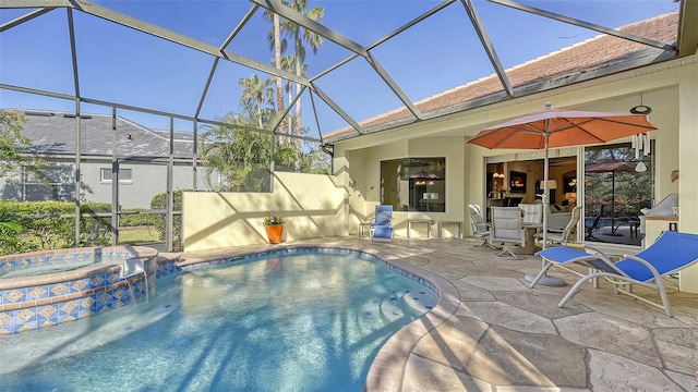 view of swimming pool with a lanai, a patio area, and an in ground hot tub