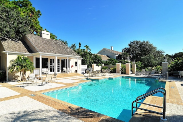 21 Bayhead Ln, Osprey, FL 34229 - community pool with a patio, a storage structure, an outbuilding, and french doors