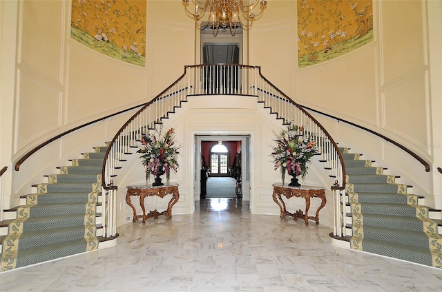 21 Bayhead Ln, Osprey, FL 34229 - foyer with a high ceiling, stairway, a decorative wall, and a chandelier