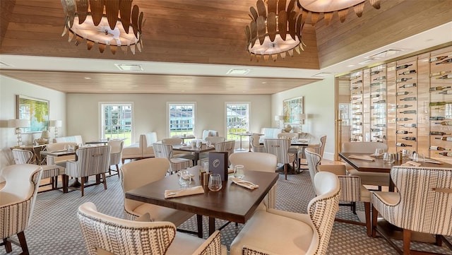 dining space with carpet floors and wooden ceiling