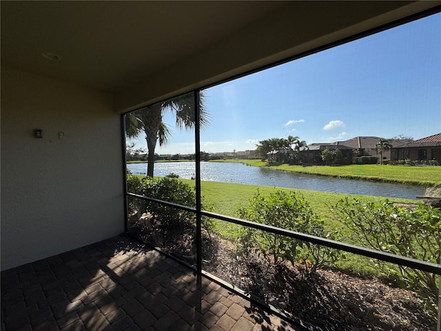 unfurnished sunroom featuring a water view