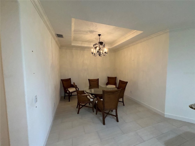 dining space with a tray ceiling, visible vents, crown molding, and baseboards