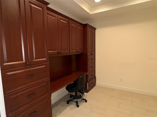 unfurnished office featuring recessed lighting, baseboards, ornamental molding, built in study area, and a raised ceiling