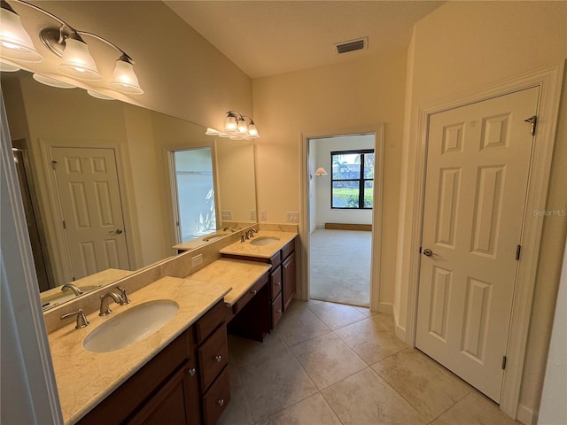 full bathroom with double vanity, a sink, visible vents, and tile patterned floors