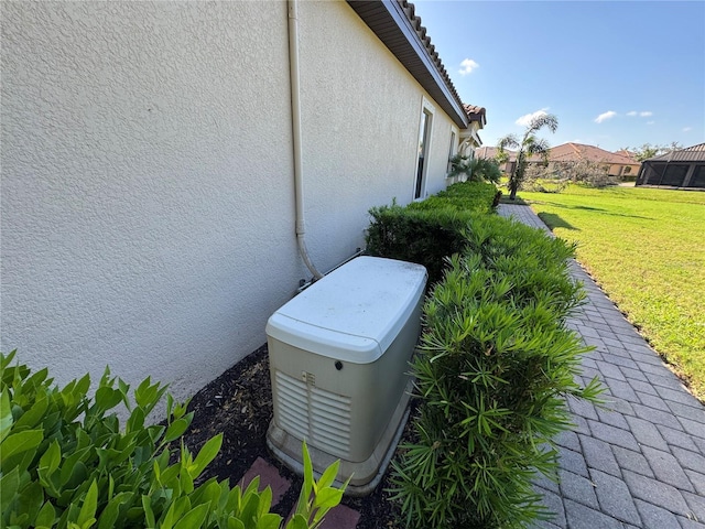 exterior details featuring a power unit and stucco siding