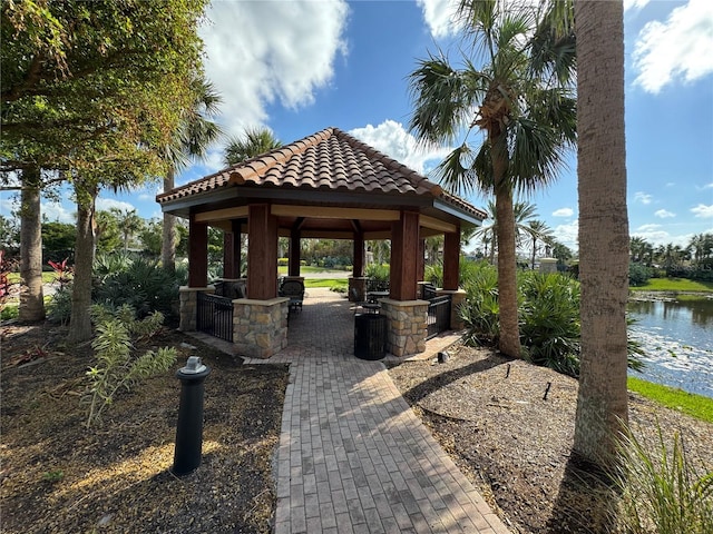 surrounding community featuring a water view and a gazebo