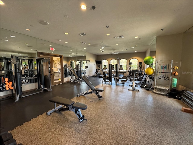 exercise room featuring recessed lighting, visible vents, and a textured ceiling