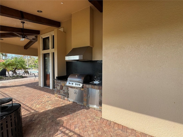 view of patio / terrace with a sink, ceiling fan, grilling area, and exterior kitchen