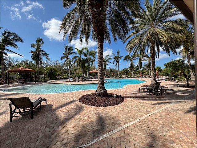 pool with a gazebo and a patio