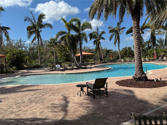 community pool with a patio area