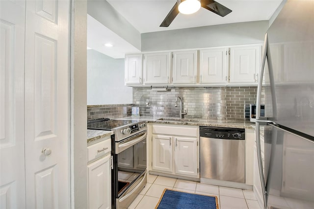 kitchen featuring white cabinetry, stainless steel appliances, sink, and light stone counters