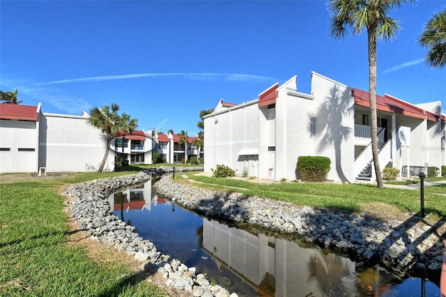 rear view of property with a lawn