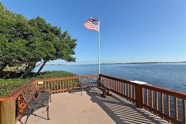 wooden terrace featuring a water view