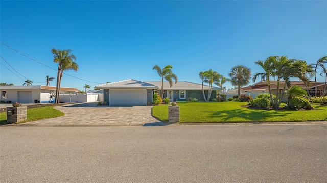 single story home with a garage and a front lawn