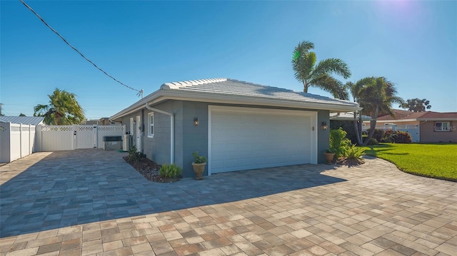 view of side of home with a lawn and a garage