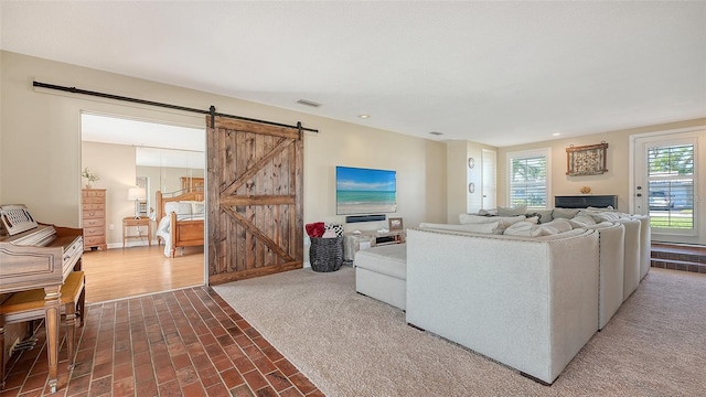 carpeted living room featuring a barn door