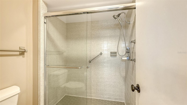 bathroom featuring toilet and walk in shower