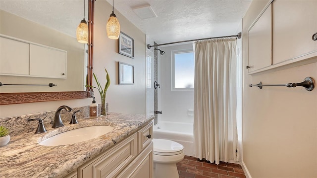 full bathroom featuring shower / tub combo, vanity, a textured ceiling, and toilet