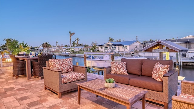 view of patio / terrace with an outdoor living space and a water view