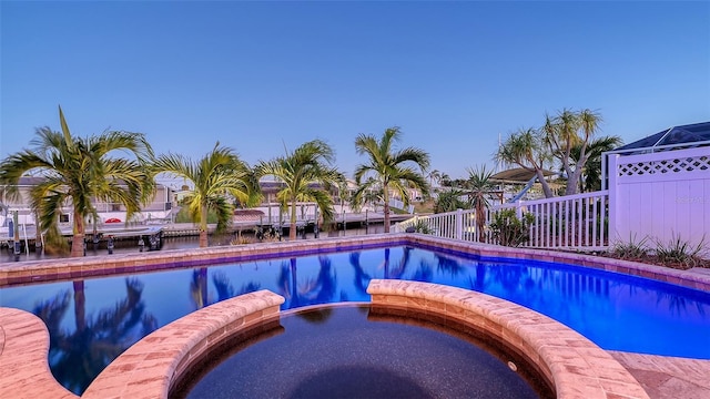 view of swimming pool featuring an in ground hot tub