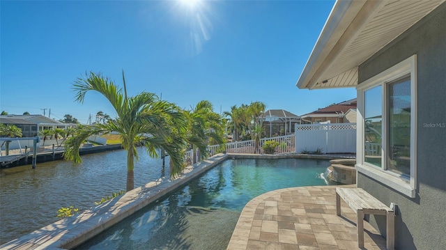 view of pool featuring a patio area and a water view