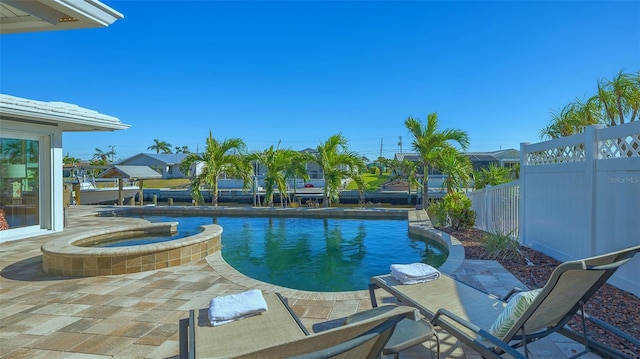 view of swimming pool featuring an in ground hot tub and a patio