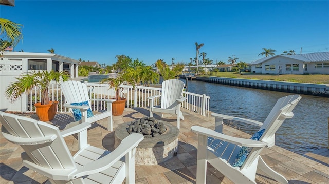 view of patio / terrace with a water view and an outdoor fire pit