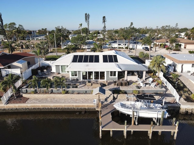 rear view of house featuring a patio and a water view