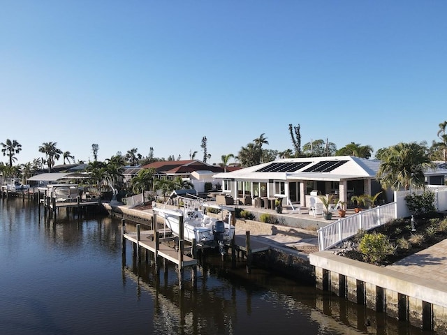 dock area with a patio area and a water view