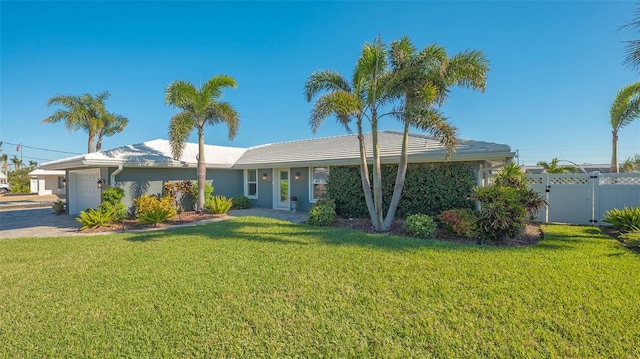 ranch-style home with a garage and a front lawn