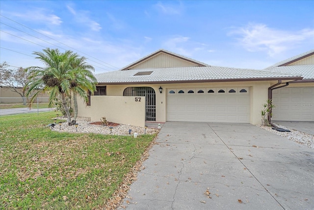 single story home with a front lawn and a garage