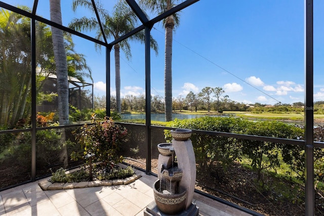 unfurnished sunroom with a water view