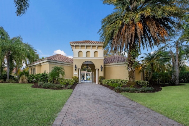 mediterranean / spanish-style house featuring a front lawn