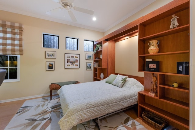 bedroom featuring ornamental molding, light hardwood / wood-style flooring, and ceiling fan