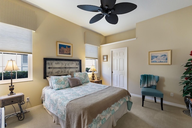 carpeted bedroom featuring multiple windows and ceiling fan