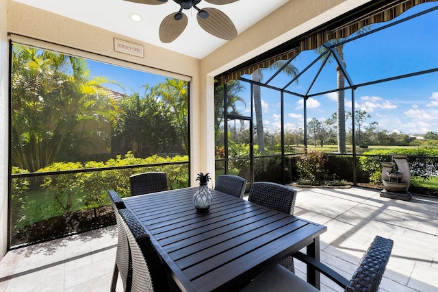 sunroom / solarium featuring ceiling fan