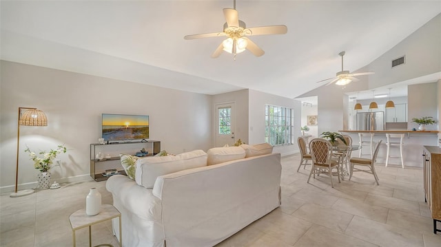 living area featuring light tile patterned floors, visible vents, a ceiling fan, high vaulted ceiling, and baseboards