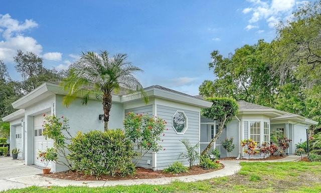 view of front of property featuring a garage and concrete driveway