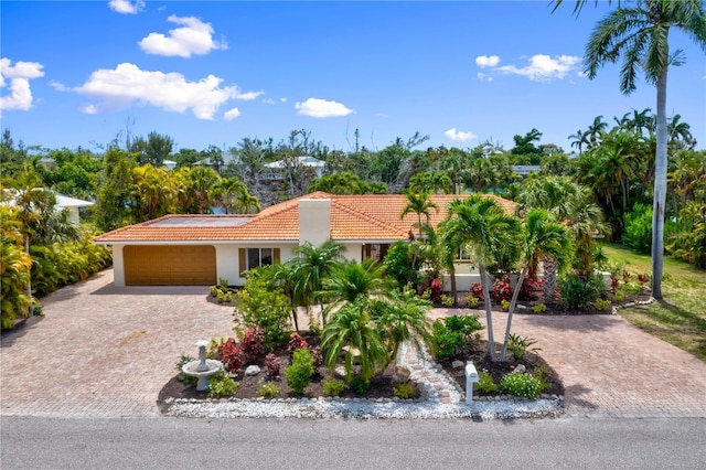 mediterranean / spanish-style home with a garage