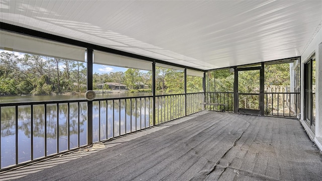 unfurnished sunroom with a water view