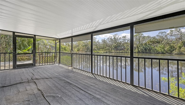 unfurnished sunroom featuring a water view