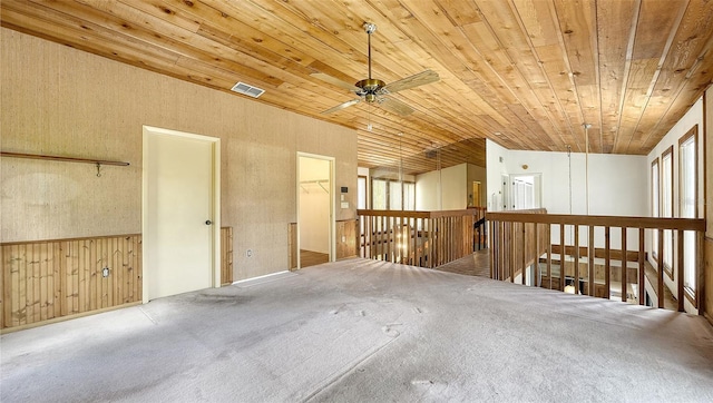 garage featuring wood walls, wood ceiling, and ceiling fan