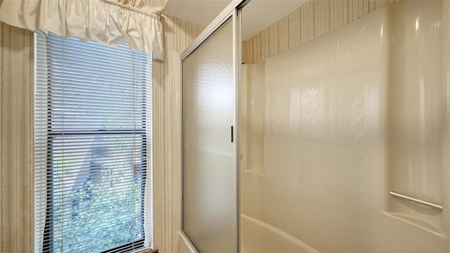 bathroom featuring a shower with shower door