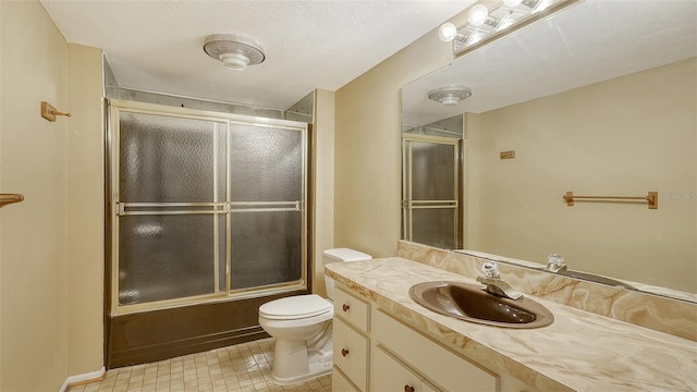 full bathroom featuring toilet, combined bath / shower with glass door, vanity, and tile patterned flooring